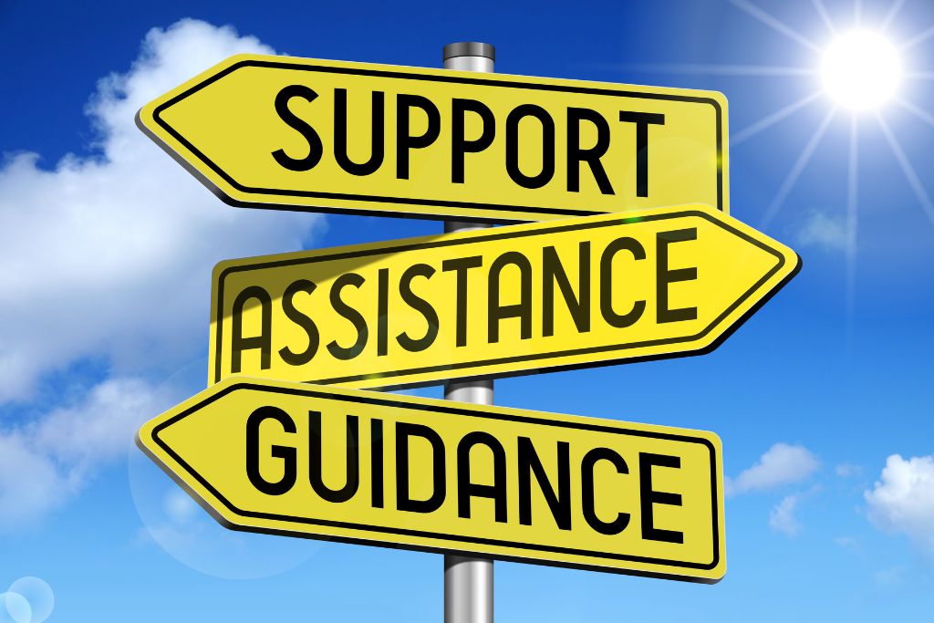 a road sign that reads "support, assistance, guidance"